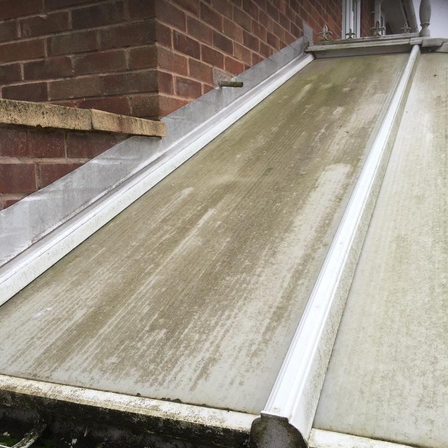 Conservatory roof before cleaning, green with algae